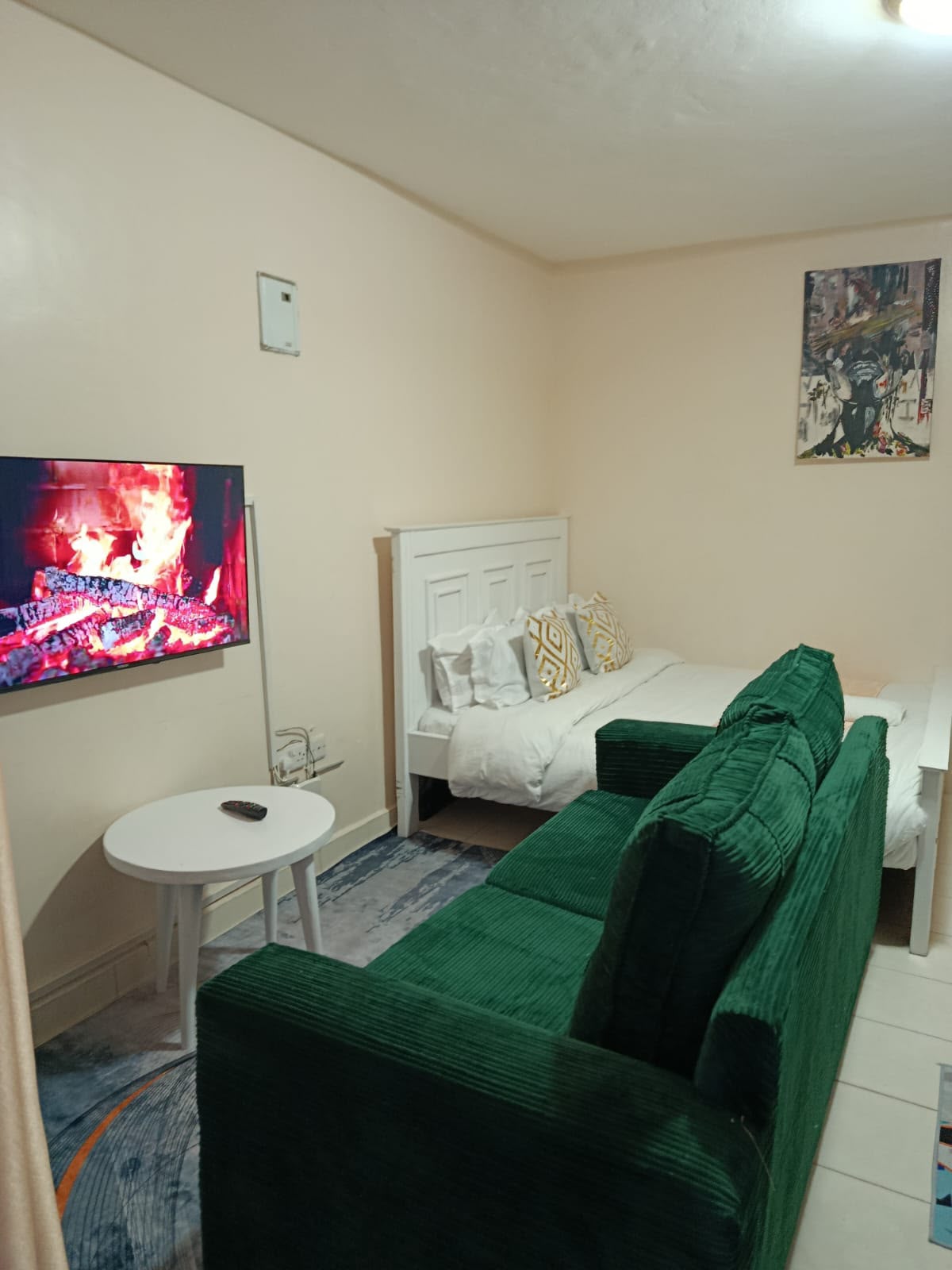 Wide view of the Ngong Road studio showing lounge and bed area