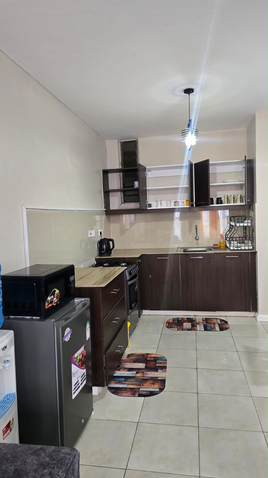 Fitted kitchen with cooker, fridge and cabinets