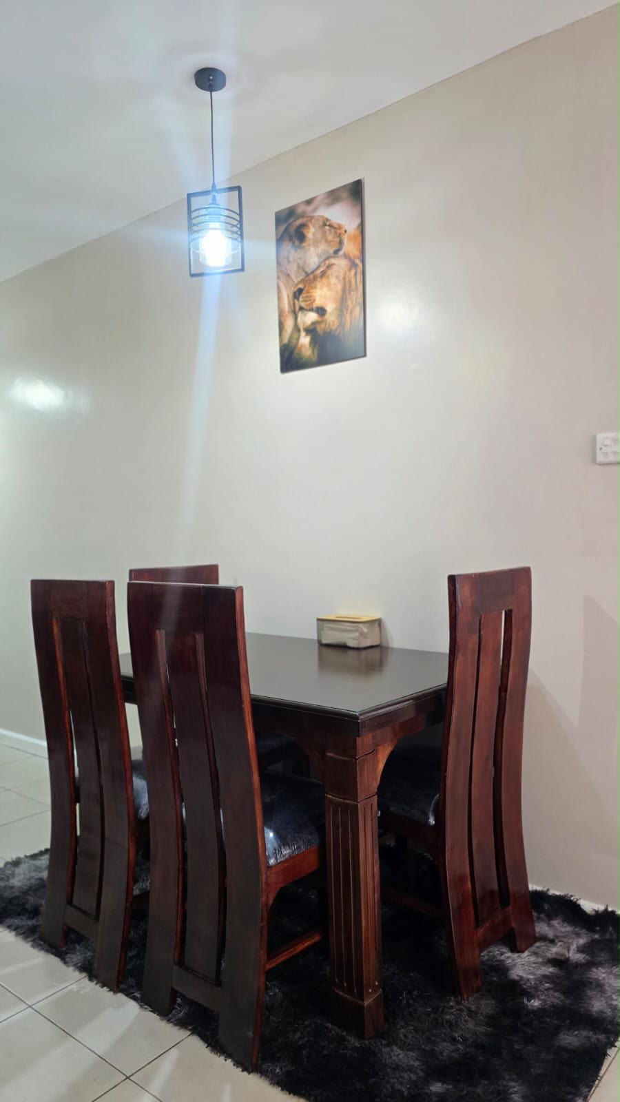Lounge with grey sectional sofa, smart TV and dining table